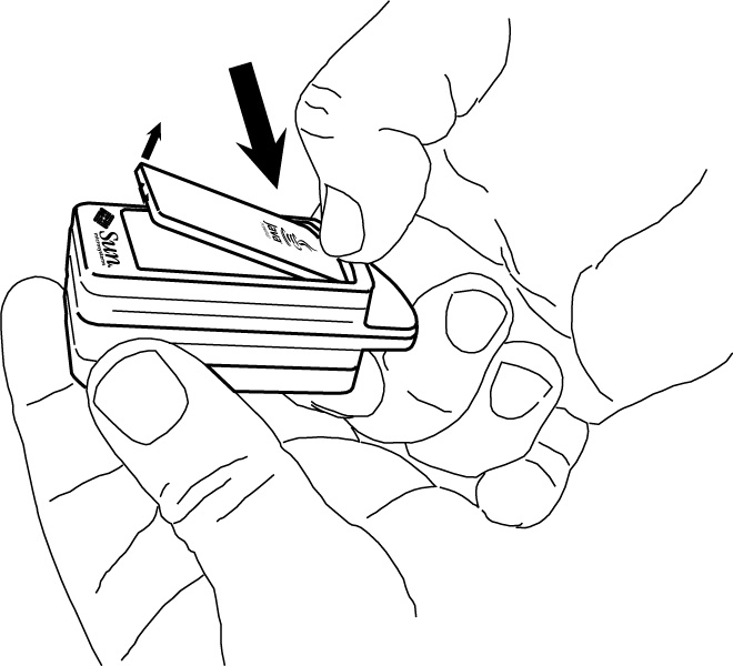 The graphic shows a Sun SPOT  being held in the left hand. The thumb of the user's right hand is pressing down on the lid just above the radio fin.  The lid is popping up on the end opposite from where the thumb is pressing down.